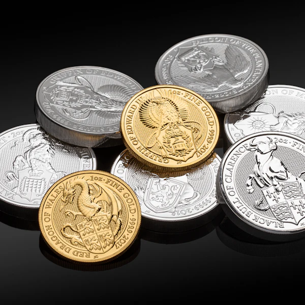 Gold and silver bullion coins together on a dark background