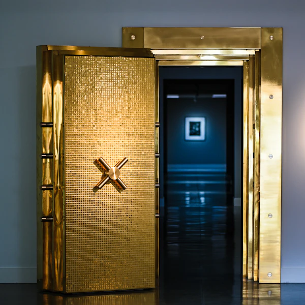 A gold-coloured vault door standing open