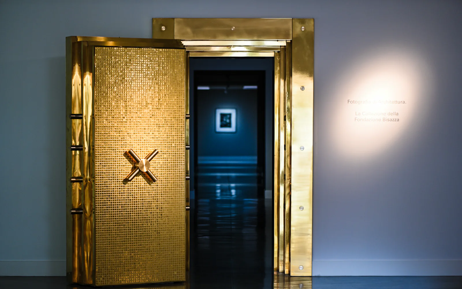 A gold-coloured vault door standing open