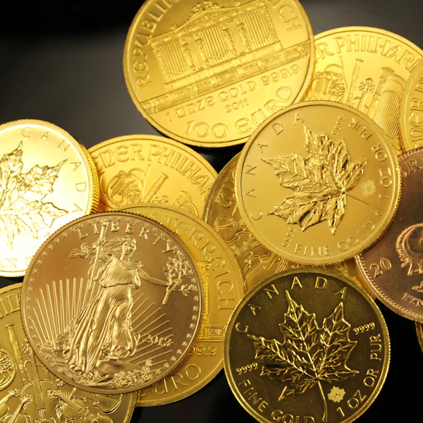 One-ounce gold bullion coins, including a Maple Leaf and an American Eagle