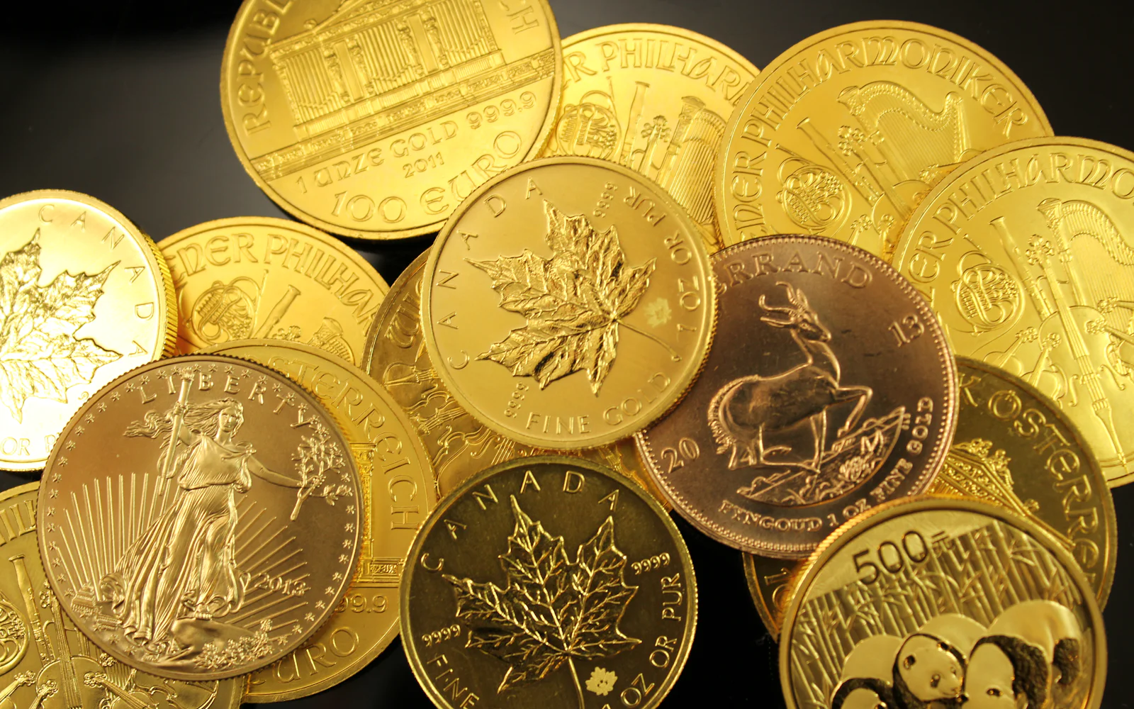 One-ounce gold bullion coins, including a Maple Leaf and an American Eagle